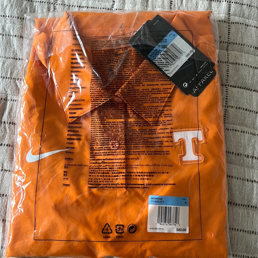 Unopened bag women’s Nike golf shirt. Tennessee logo on front